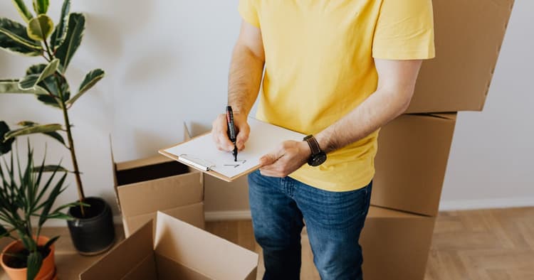 Home inspector examining house systems with clipboard and checklist