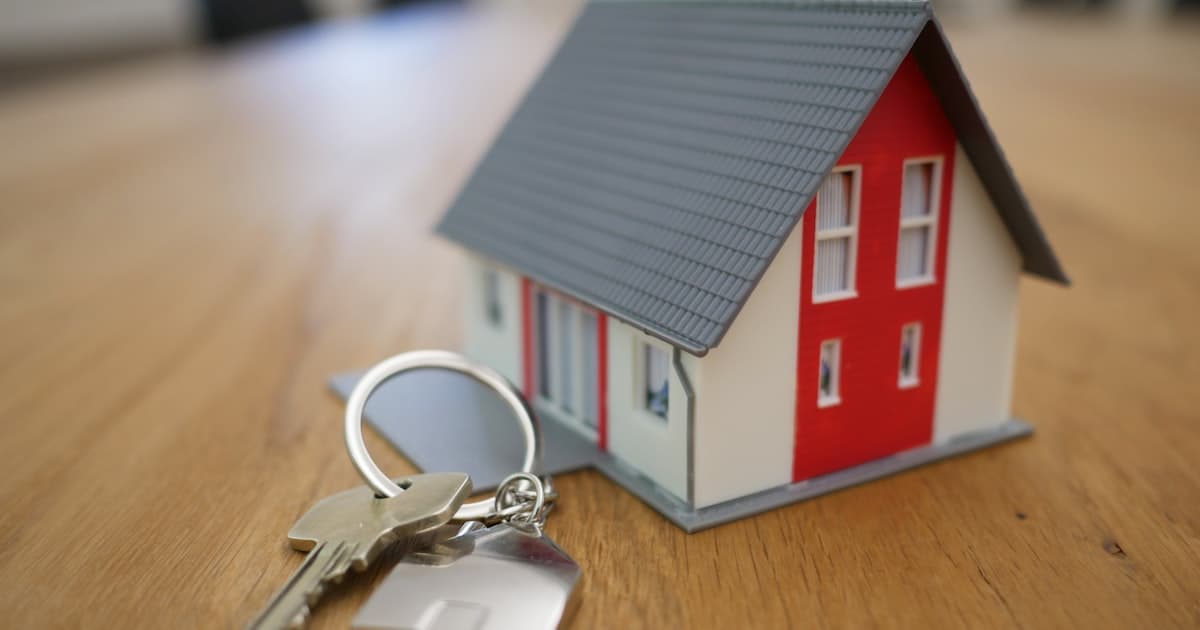 Person holding house keys after a successful home offer letter acceptance