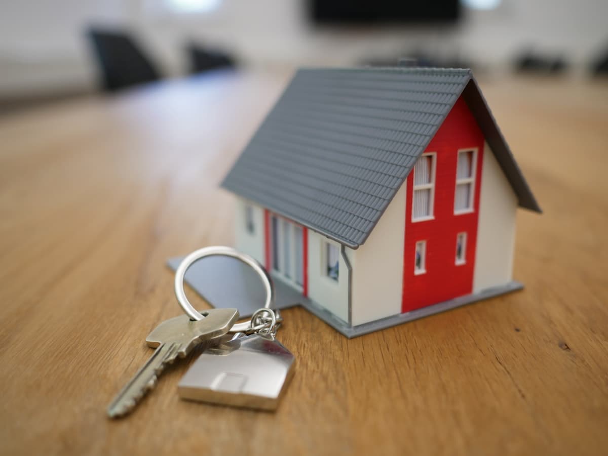 Small wooden house model on a table representing a home purchase offer