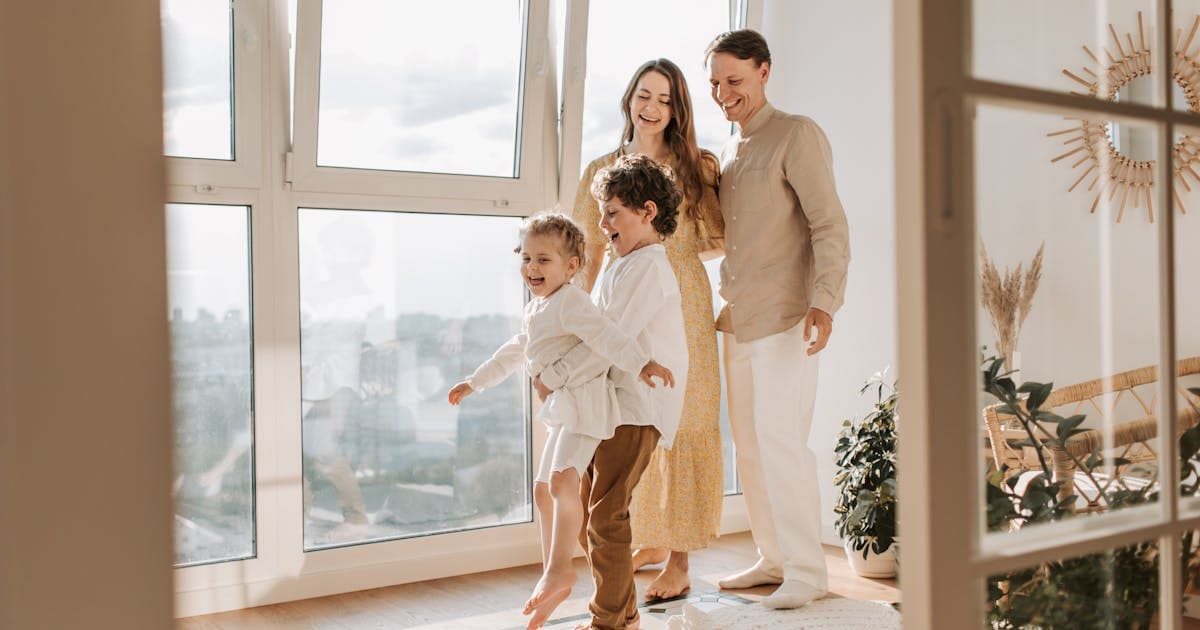 New homeowner holding house keys after closing day
