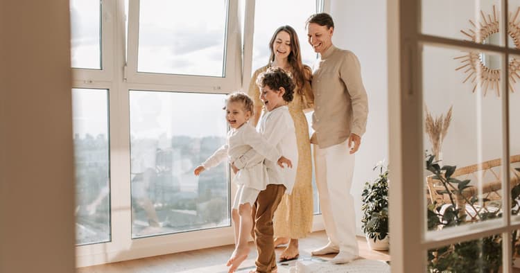 New homeowner holding house keys after closing day