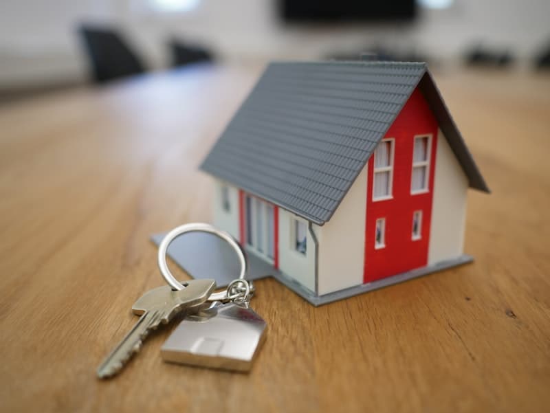 How income and debt-to-income ratio affect home affordability Model house with keys representing home affordability and debt-to-income ratio