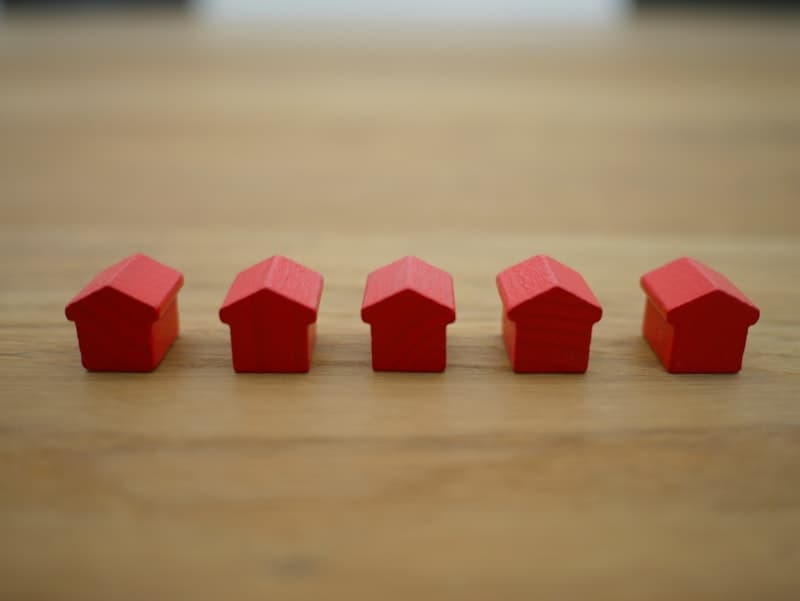 Understanding down payment requirements and private mortgage insurance Row of small house models representing down payment and PMI options for home buyers