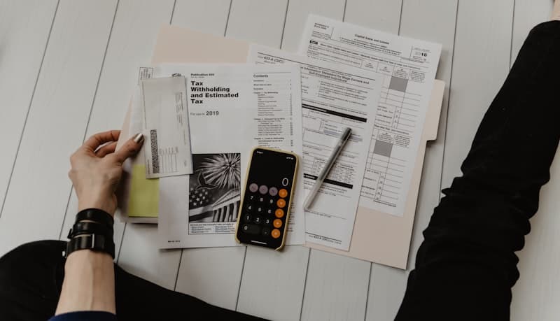 How credit score and interest rates impact your mortgage payment Person reviewing financial documents to check credit score and mortgage interest rates